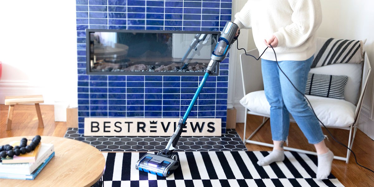 Person using Shark Vertex UltraLight Corded Stick Vacuum on carpeted area